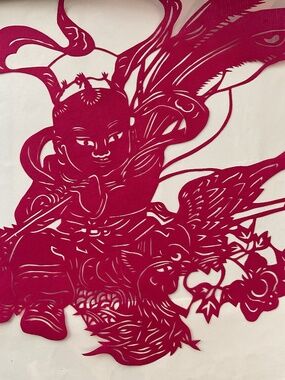 Traditional handmade paper cut in red,
